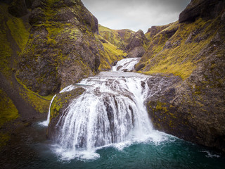 View from flying drone of Stjornarfoss waterfall. Impressive summer sunrise in Iceland, Europe. Beauty of nature concept background. Travel to Iceland..