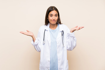 Young doctor woman over isolated background having doubts with confuse face expression