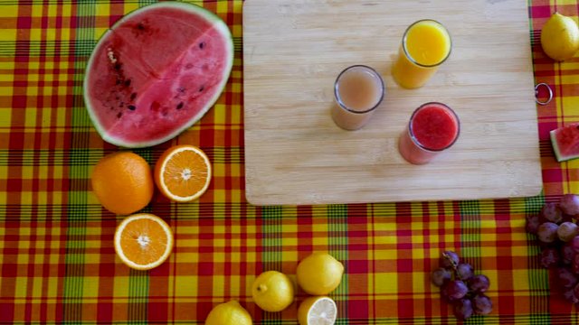 Cinematic 4K Slow traveling movement on fruit platter containing colorful assortment of fresh fruits : orange, lemon, watermelon and grapefruit.