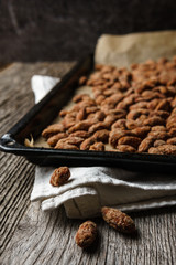 Burnt almonds just taken out of the oven - vertical, focus on foreground