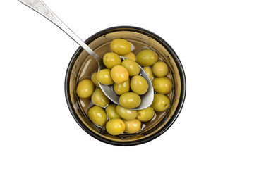 Green olives in bowl with spoon, top view