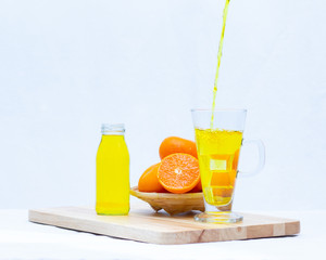 Yellow orange juice in the glasses and bottle on white background,