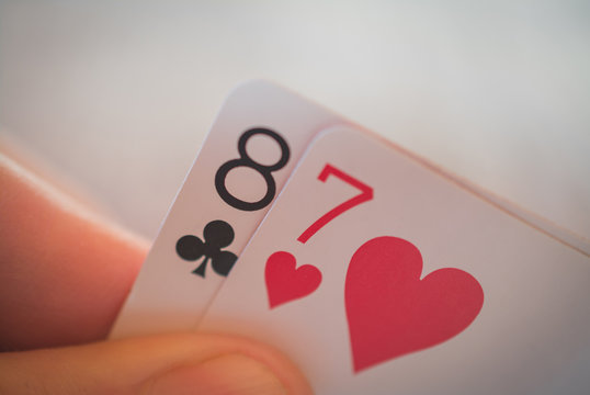 Eight and seven, Playing cards in hand on the table, poker nands