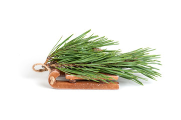 spruce branch on wooden sled isolated on a white background