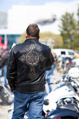 Fototapeta na wymiar biker in a black jacket calls a friend