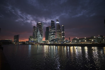 Fototapeta premium Moscow city at night on a background of purple sky with pink clouds