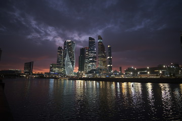 Fototapeta premium Moscow city at night on a background of purple sky with pink clouds