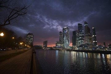 Moscow city at night on a background of purple sky with pink clouds