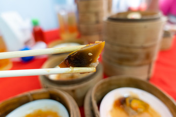 Wooden chopsticks are dim sum on the table.