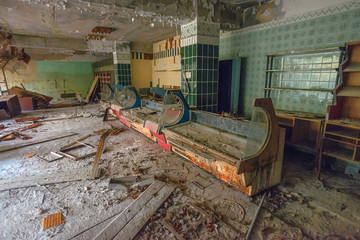 interior of an abandoned grocery store and broken .trading counters in the city of Pripyat in the Chernobyl exclusion zone. Everything was looted after the Chernobyl disaster