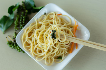 Spaghetti lines on chopsticks with on the table,