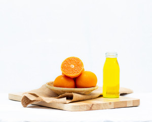 Yellow orange juice in a bottle on white background,