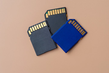Fototapeta na wymiar Close-up three memory cards lie on a beige table