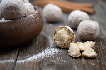 Wooden bowl with apple and spice donut holes, sprinkled with cinnamon sugar