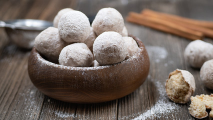 Wooden bowl with apple and spice donut holes, sprinkled with cinnamon sugar