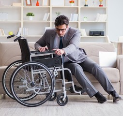 Dsabled businessman on wheelchair working home