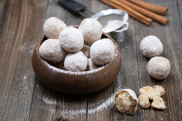 Wooden bowl with apple and spice donut holes, sprinkled with cinnamon sugar