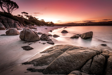 Dreamlike sunset on Binalong Bay in Tasmania, also called the Bay of Fires, a picturesque landscape...