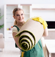 Professional female cleaner cleaning carpet