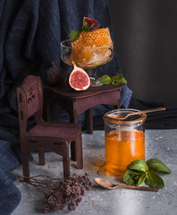 Honey in a jar and honey in a honeycomb on a dark background