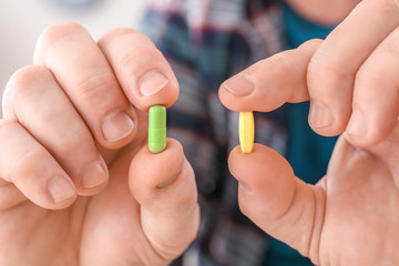 Elderly man with pills at home, closeup