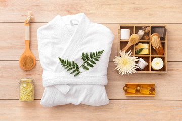 Obraz na płótnie Canvas Bathrobe and set of spa items on wooden background