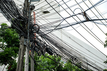 Tangle of Electrical cables and Communication wires on electric pole.