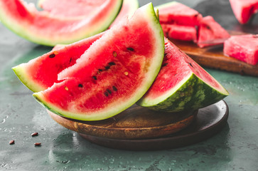Plate with slices of ripe watermelon on table
