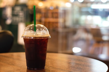 Black coffee on wooden table in coffee shop or restaurant.