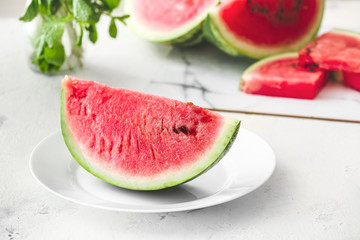 Plate with slice of ripe watermelon on table