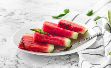 Plate with sliced watermelon on table