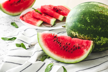 Ripe sweet watermelon and slices on table