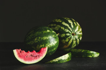 Sweet ripe watermelons on dark background