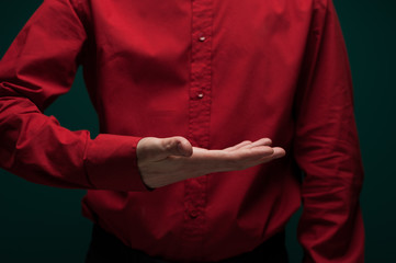 Young man in blood red shirt hold invisible object