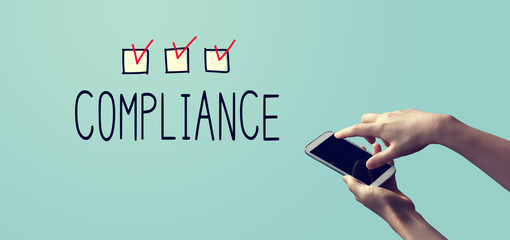 Compliance concept with person holding a white smartphone