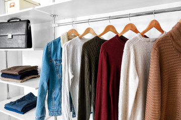 Obraz premium Big wardrobe with clothes in dressing room