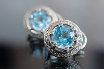 beautiful vintage white gold earrings pair with blue topaz natural gems on dark background