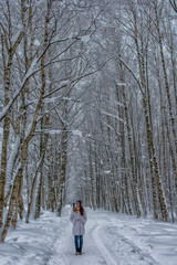 girl on a forest road in winter