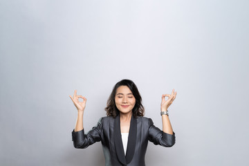 Woman meditating holding her hands in yoga gesture isolated on white background