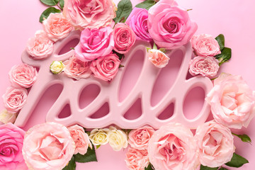 Word HELLO and beautiful roses on color background