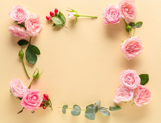 Frame made of beautiful roses on color background
