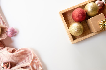 Christmas composition. Christmas balls and gift box decorations on knit background. Christmas, winter, new year concept. Flat lay, top view, copy space.