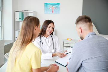 Fototapeta premium Couple visiting female gynecologist in clinic