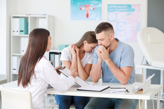 Sad couple at a gynecologist appointment in clinic