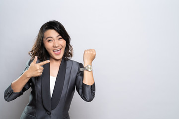 Happy woman holding hand with wrist watch