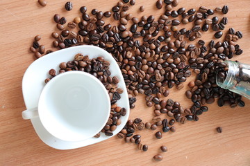 cup of coffee and beans on wooden table