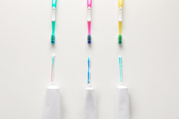 Tooth brushes and paste on light background