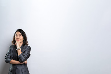 Obraz premium Happy woman thinking and standing isolated over white background