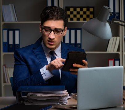 Auditor checking the accuracy of financial statements with calcu