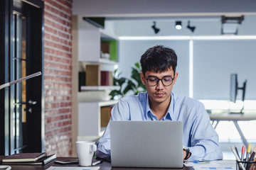 asian businessman woking with laptop and paper work on desk  at office.digital workflow online business lifestyle concept.